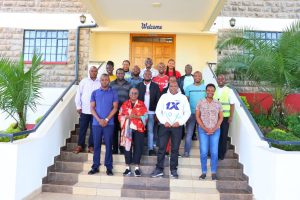 Staff pose for a group photo after engaging a successful retreat